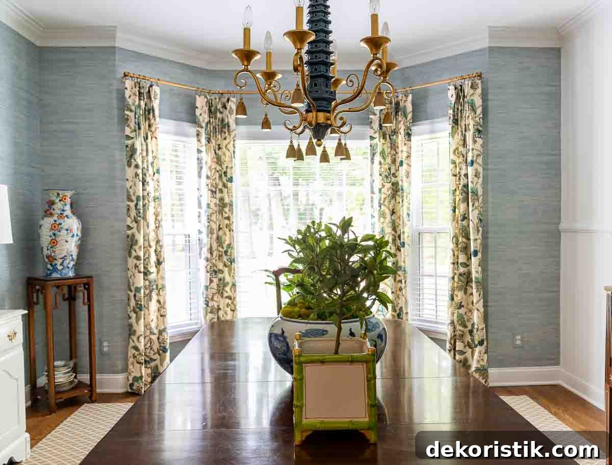 traditional style pleated draperies in the bay window of a dining room with blue grasscloth wallpaper