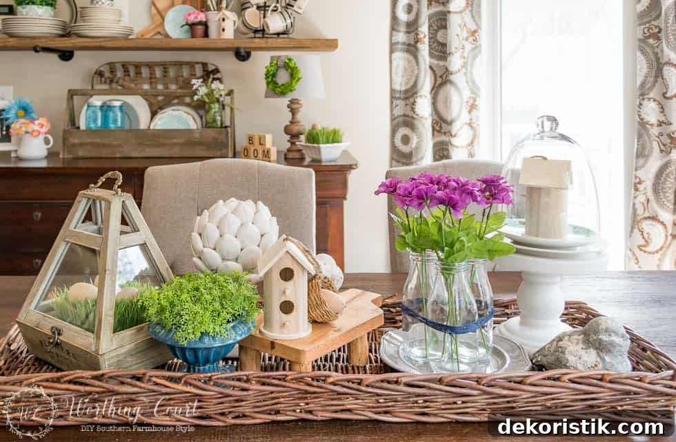 Farmhouse kitchen table spring centerpiece with pinky purple flowers and greenery.