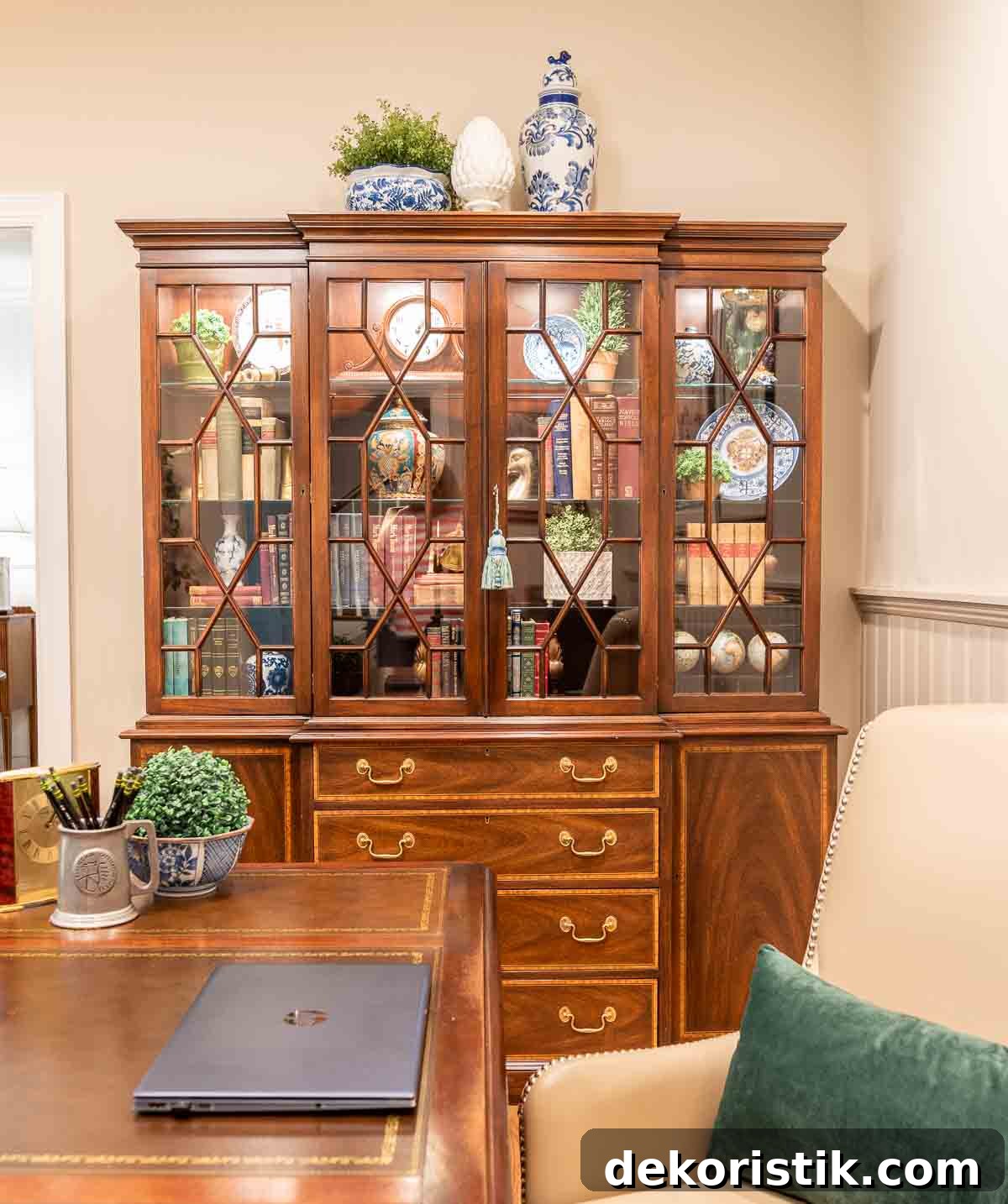 a traditional china hutch in a home office filled with traditional decorative objects and books