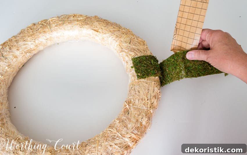Wrapping the moss around the wreath form.