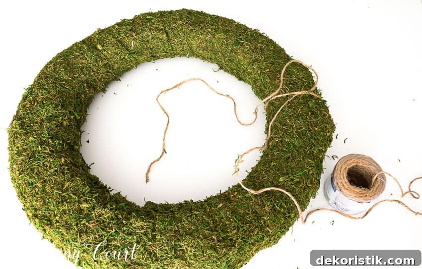 Wrapping twine around the moss covered wreath.