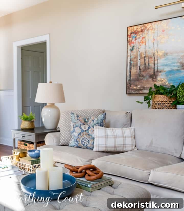neutral colored couch in a living room with blue and white pillow assortment