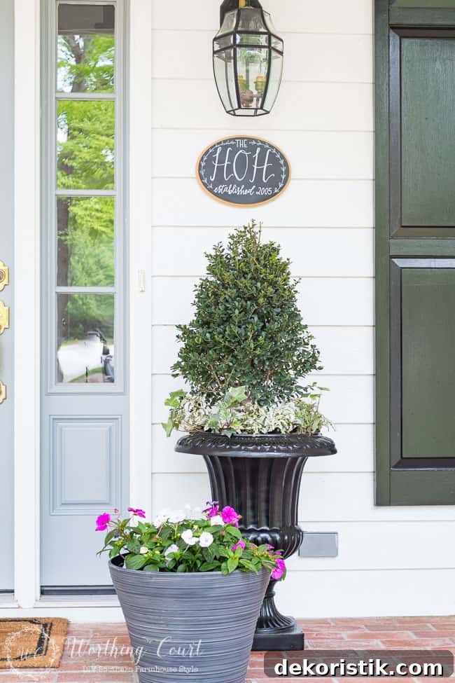 A container full of purple and white flowers on the porch.