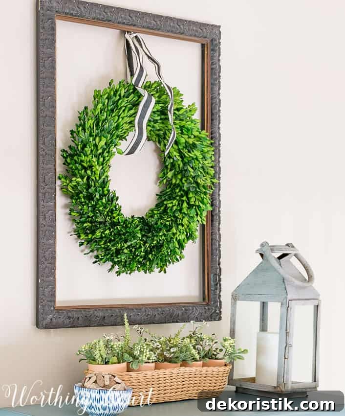 Hang a boxwood wreath inside an old empty picture frame .