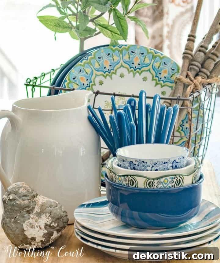 Centerpiece with blue white and green dishes on a breadboard.