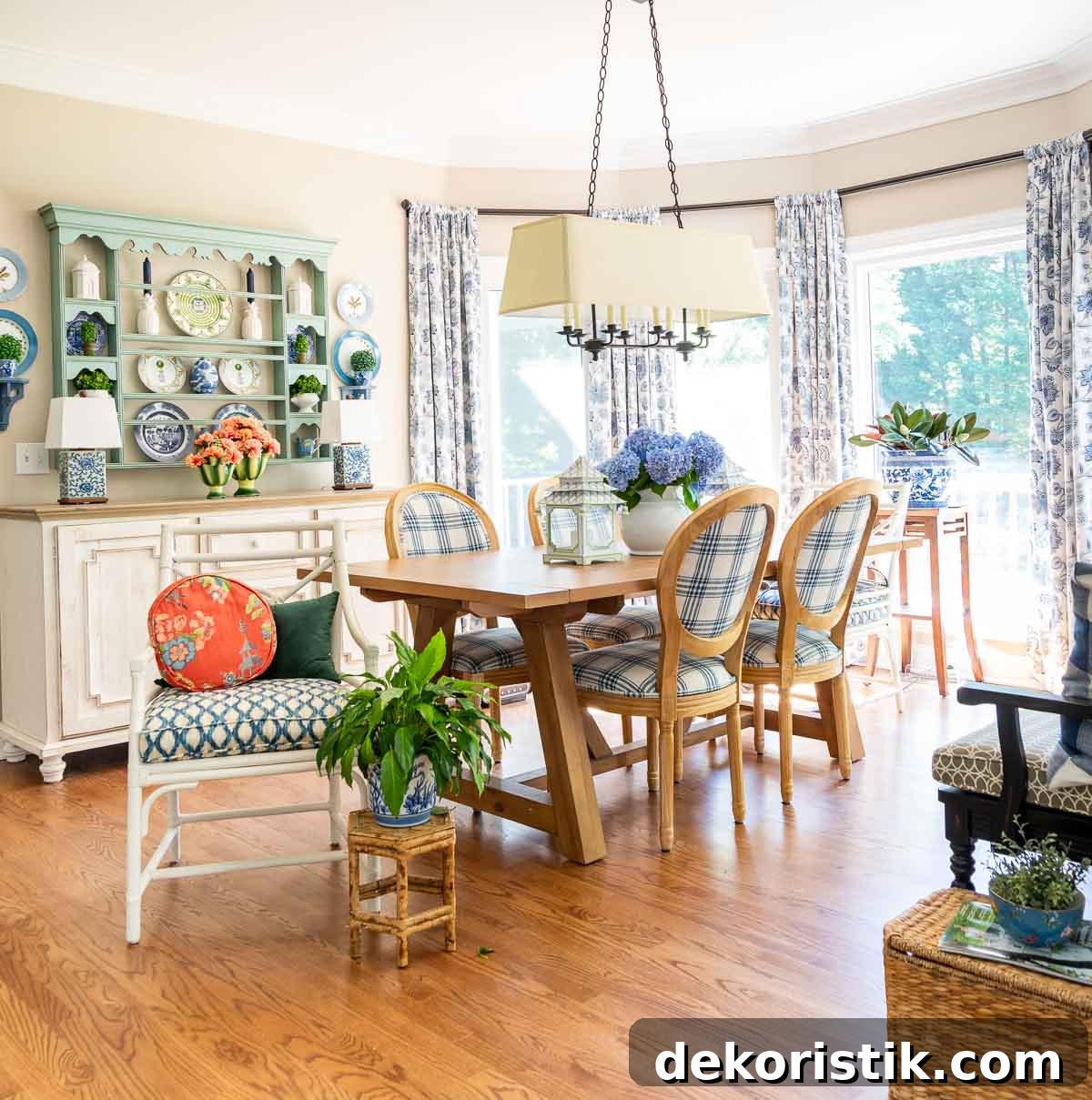 breakfast room with a large bay window decorated for summer