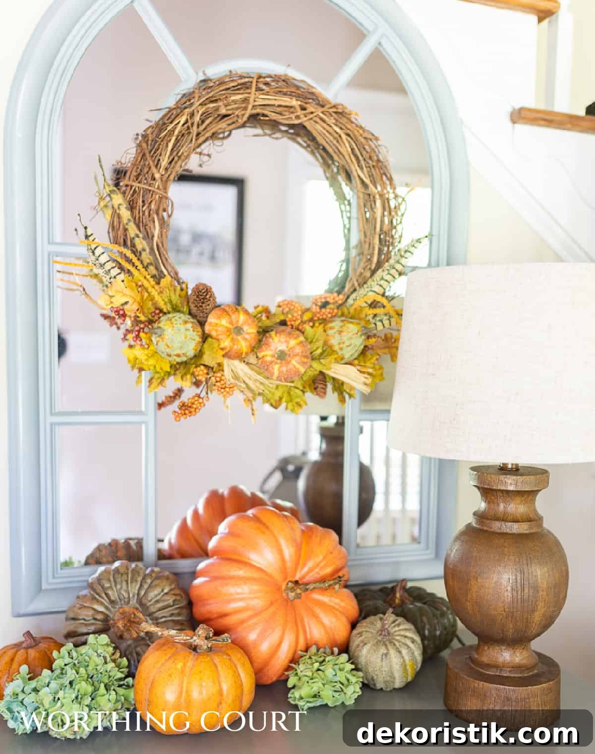 foyer table with diy fall wreath and assortment of pumpkins