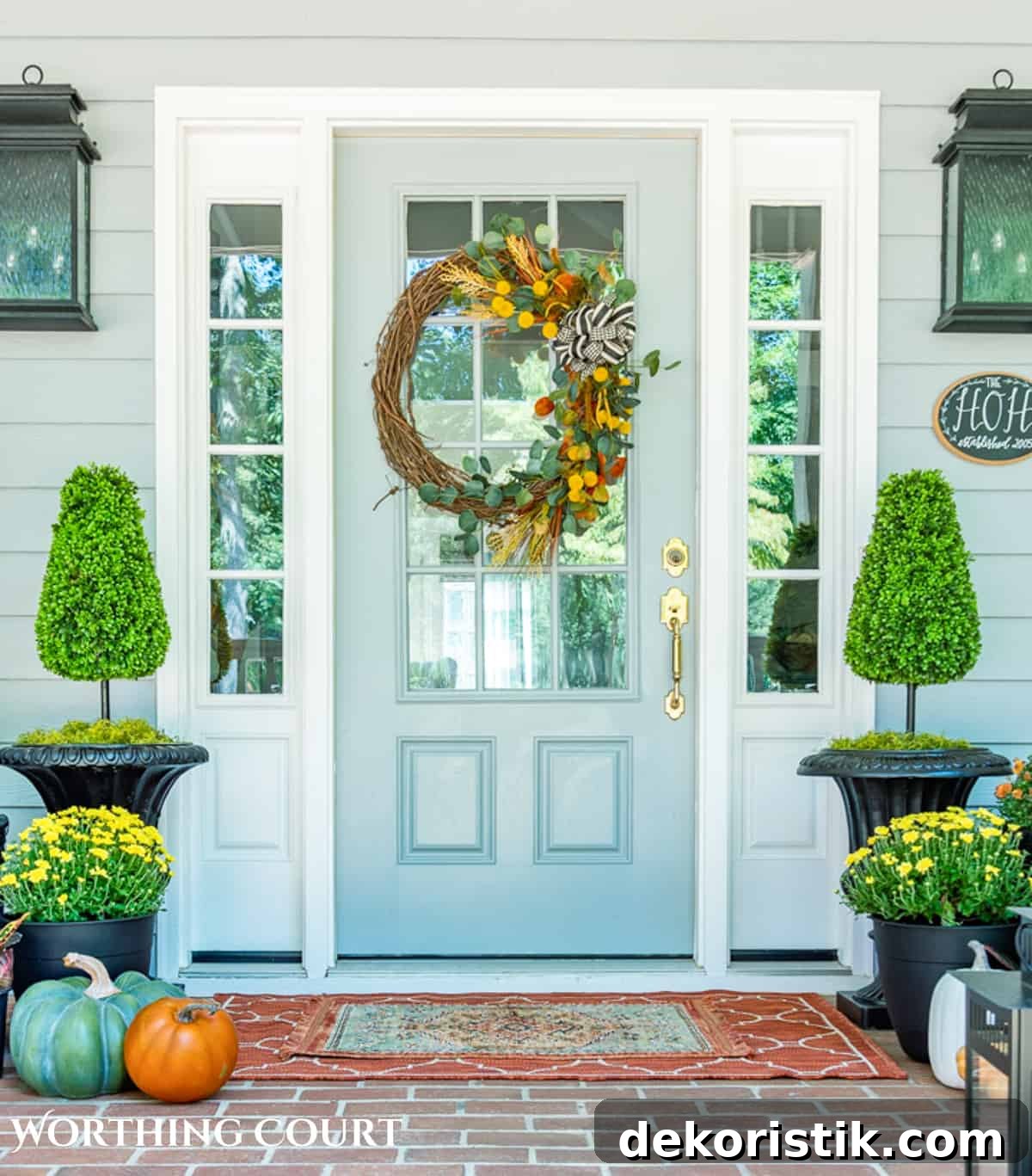 diy fall grapevine wreath with traditional fall colored picks on a gray front door