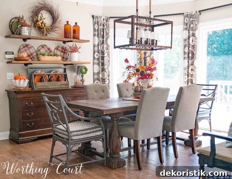 Breakfast room decorated for fall.   There is a fall centerpiece on the table, and the open shelving all decorated for fall.