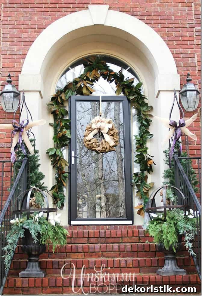 The front stoop decorated with holly and ivy on the porch.