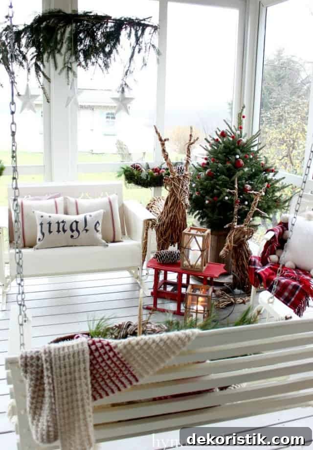 Twig deers, a small swing bench and a small Christmas tree is on the white porch.