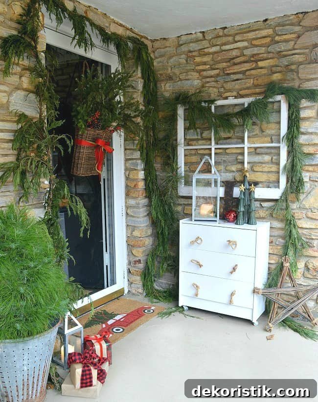 The front porch of a house with a brick facade and a basket hanging on the door filled with evergreen.