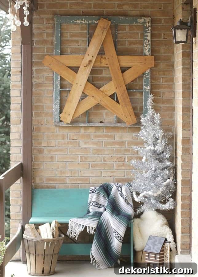 A wooden star in a picture frame is above a sitting bench on the porch.