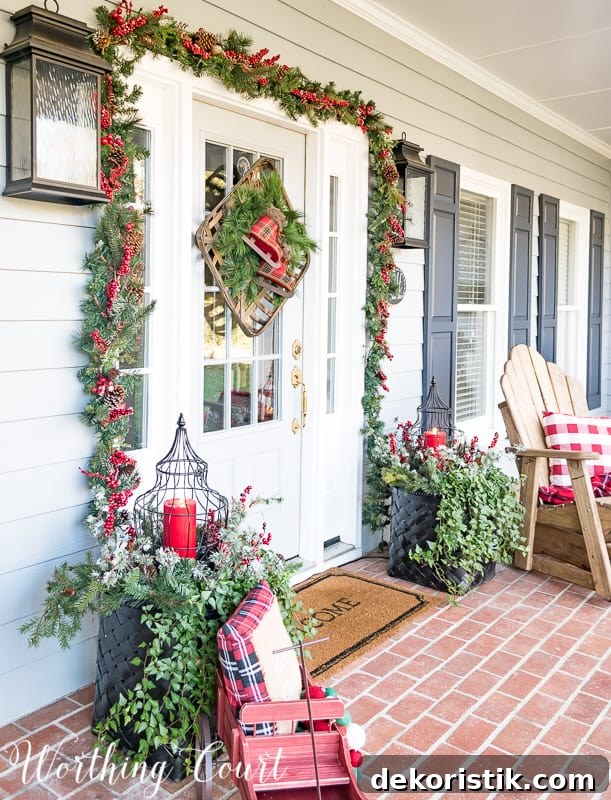 Front porch Christmas decor with a welcome mat.