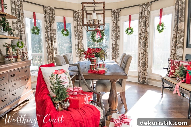 Christmas wreaths suspended with plaid ribbon in a bay window #christmas #christmasdecor #christmaswreath #tartanplaid