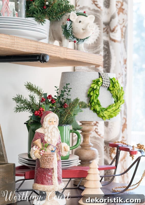 Christmas vignette with Santa Claus and greenery #christmas #christmasdecor #santaclaus