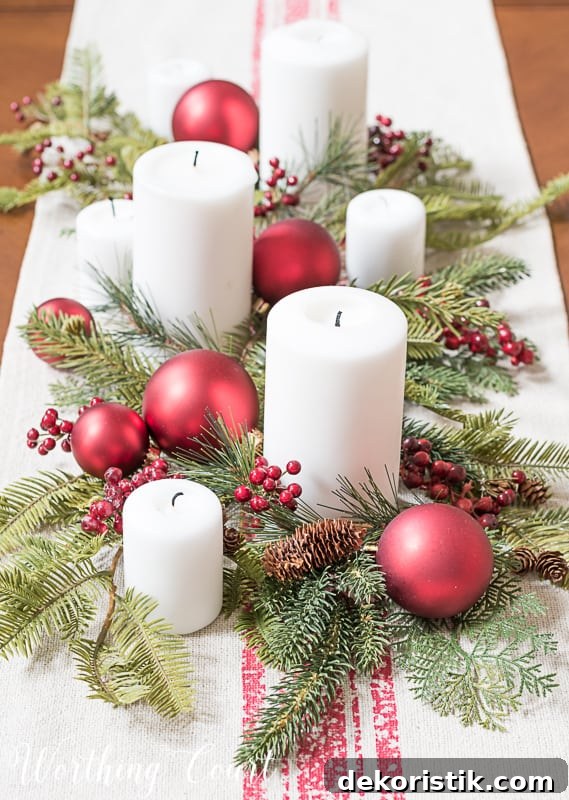 Christmas centerpiece with faux greenery, white candles, red berries and red Christmas tree ornaments #christmasdecor #centerpiece