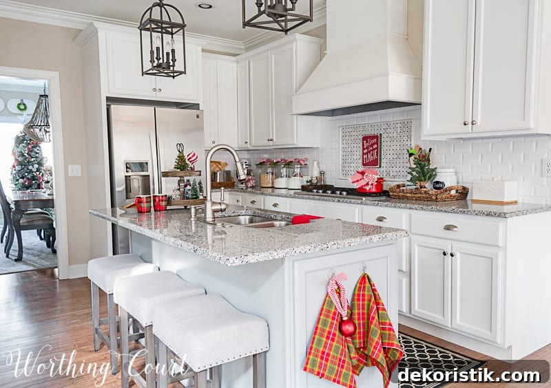 There are holiday tea towels hanging on the kitchen island.