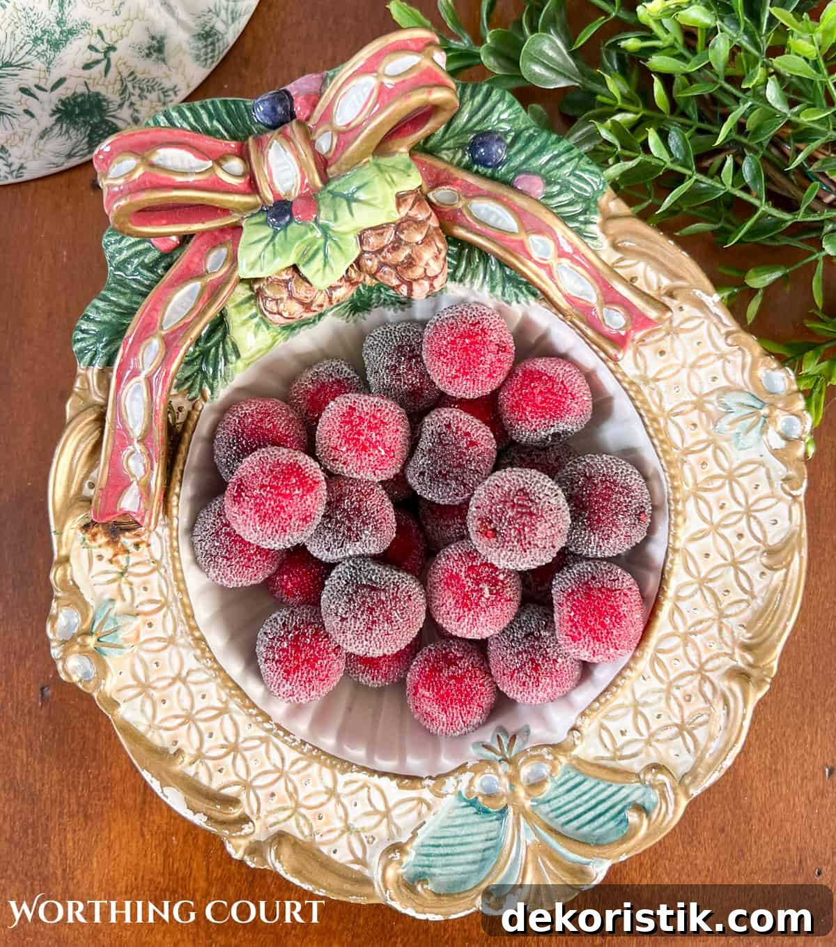 white and gold decorative Christmas bowl filled with faux red berries
