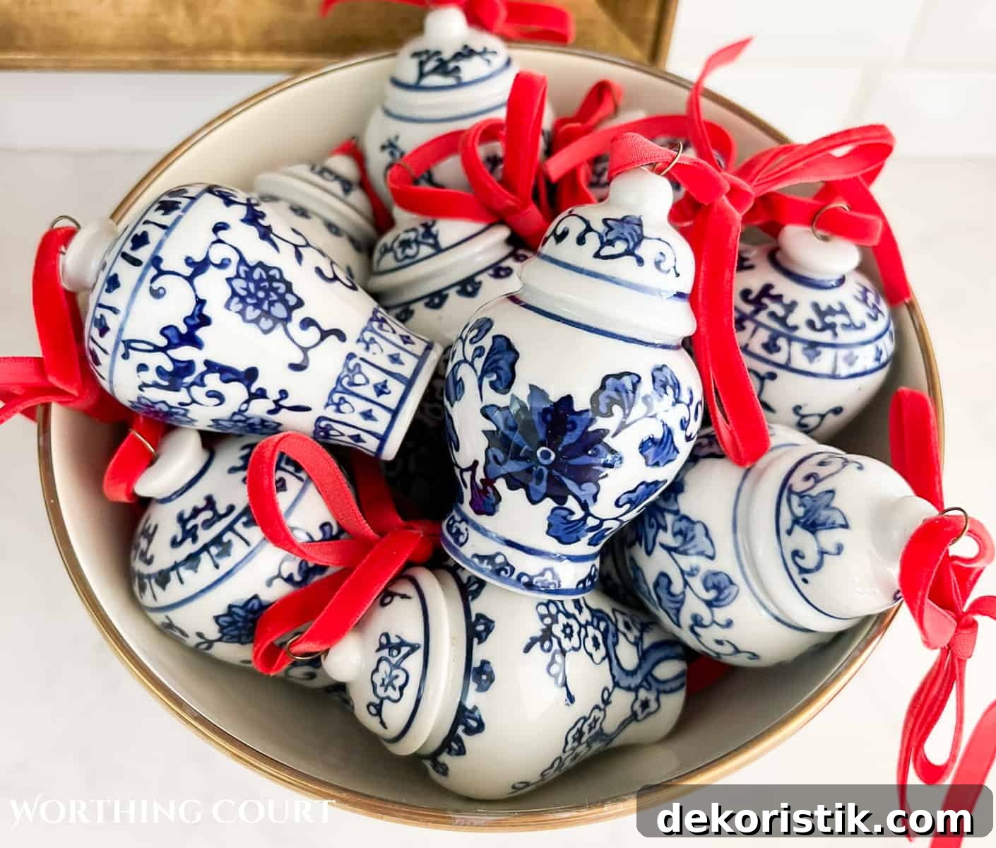 bowl filled with minature blue and white ginger jar Christmas ornaments with red velvet ribbon bows