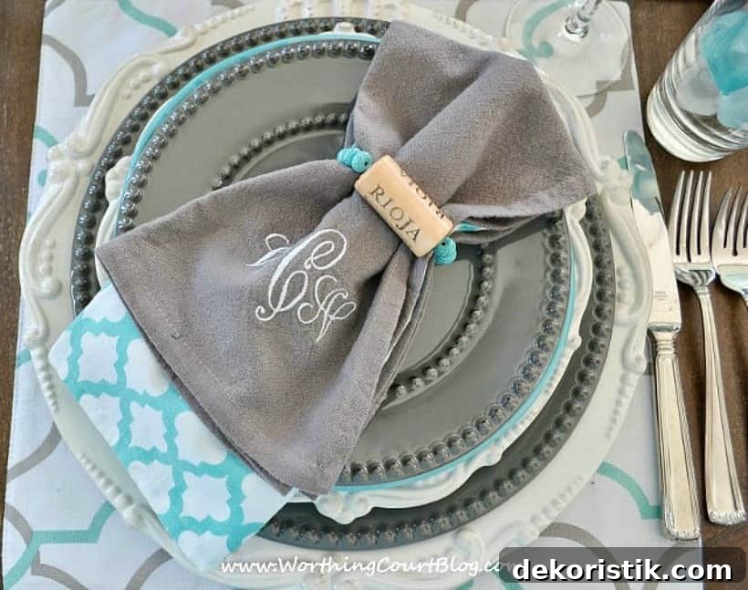 place setting with gray and white dishes and diy wine cork napkin rings