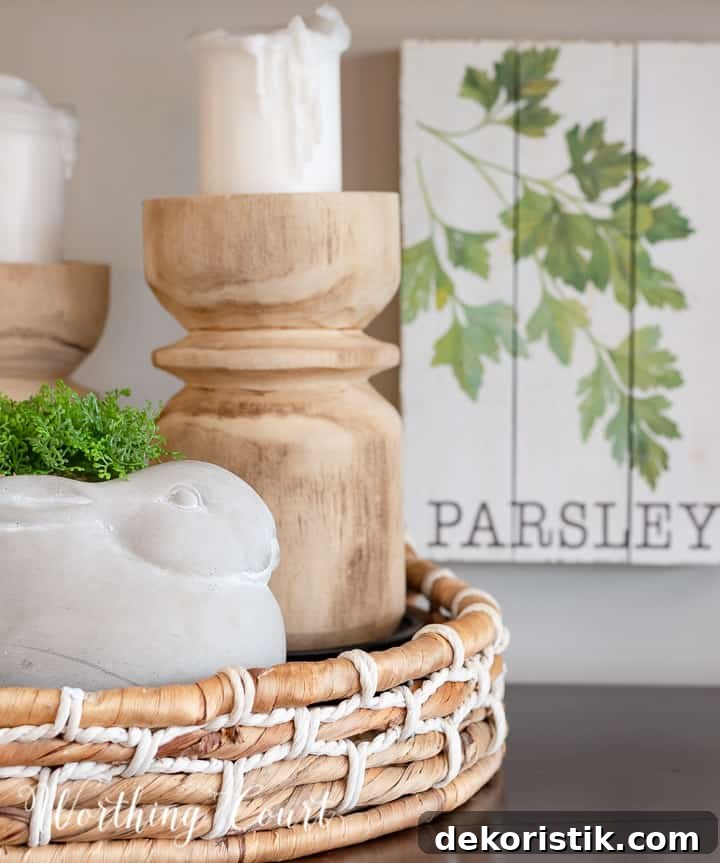 Spring Home Decor Ideas to Refresh Your Space 16 vignette with wood candlesticks and a concrete bunny in a round basket tray