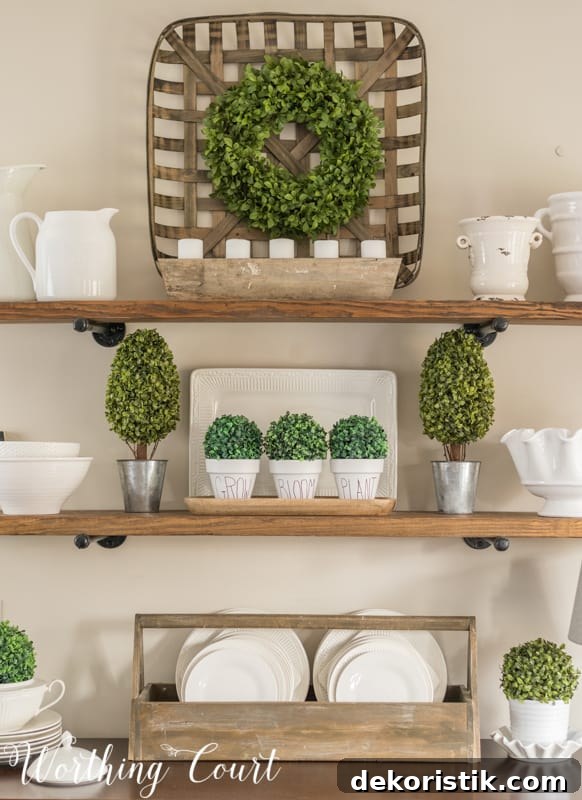 A bright green wreath on a wooden tray on the shelf in the dining room.