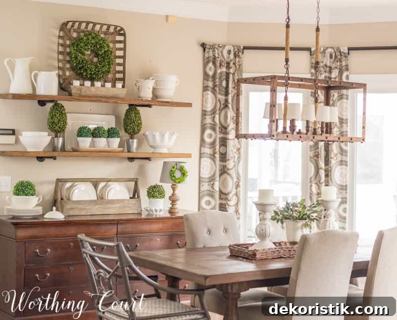 A wooden table with a light fixture above the table and a wooden hutch beside it.
