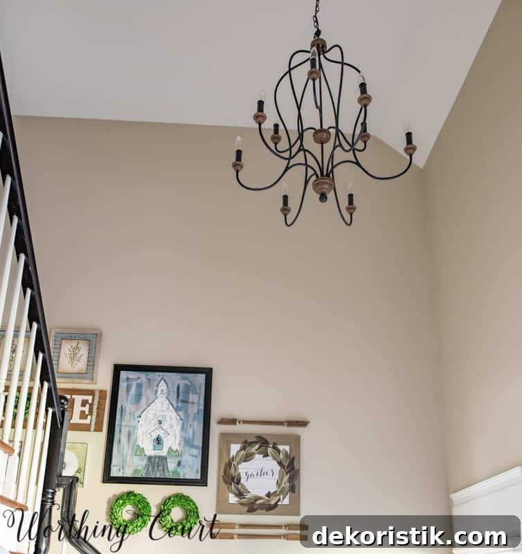 Entryway Makeover Reveal: DIY Ideas Using What You Have 11 Artwork is on the wall by the stairs.