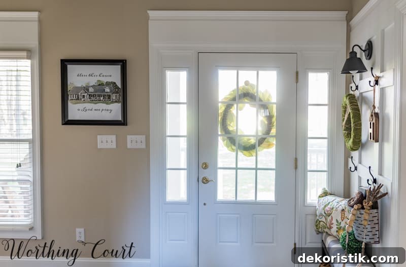 Entryway Makeover Reveal: DIY Ideas Using What You Have 15 The front door with glass and a wreath hanging on the outside of the door.