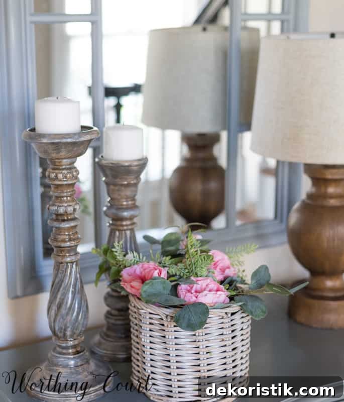 Entryway Makeover Reveal: DIY Ideas Using What You Have 18 Foyer vignette with pink roses and gray candlesticks.