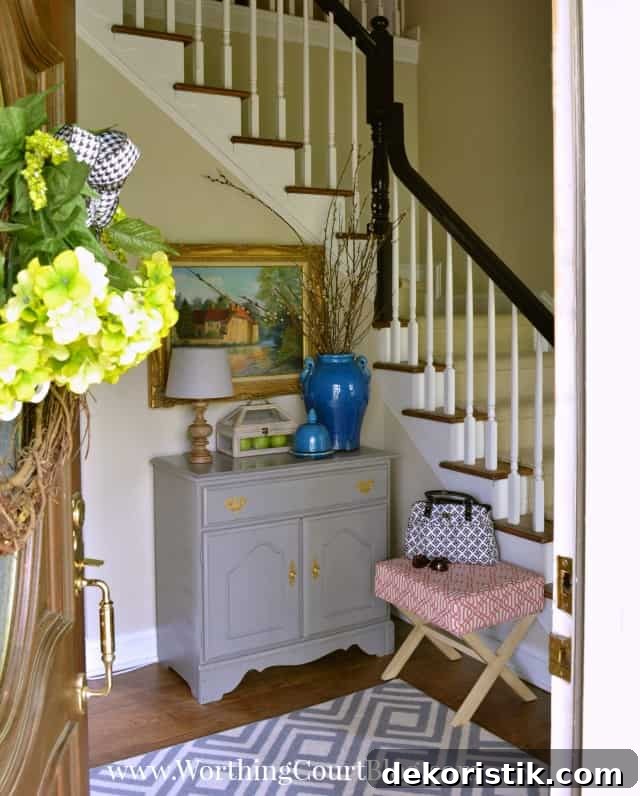Entryway Makeover Reveal: DIY Ideas Using What You Have 4 Foyer BEFORE makeover with a blue vase on a side table.