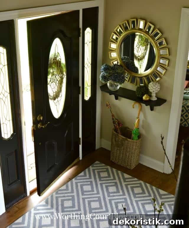 Entryway Makeover Reveal: DIY Ideas Using What You Have 5 There is a blue and white rug and a sunburst mirror at the entryway.
