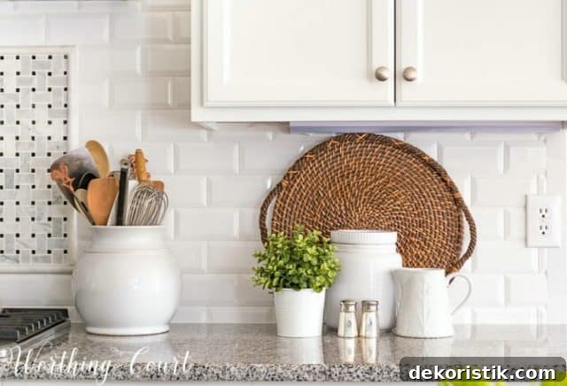 white-beveled-subway-tile-backsplash-with-granite-counters-and-white-kitchen-accessories.