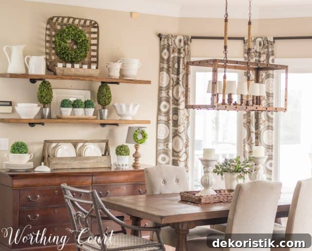 farmhouse style open shelves filled with white decor accents, dining table with white centerpiece, tobacco basket, faux greenery, industrial light fixture