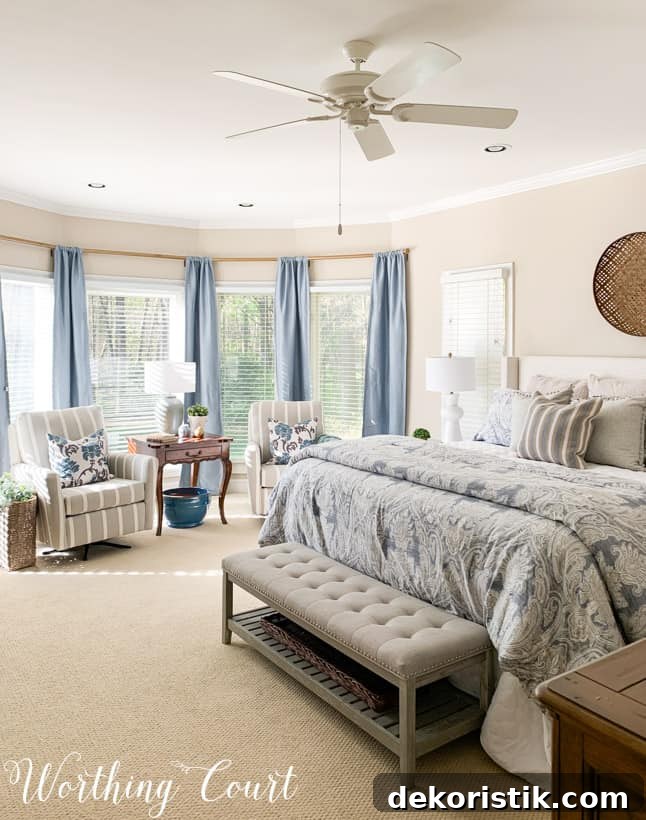 bedroom bay window sitting area with chairs and blue draperies