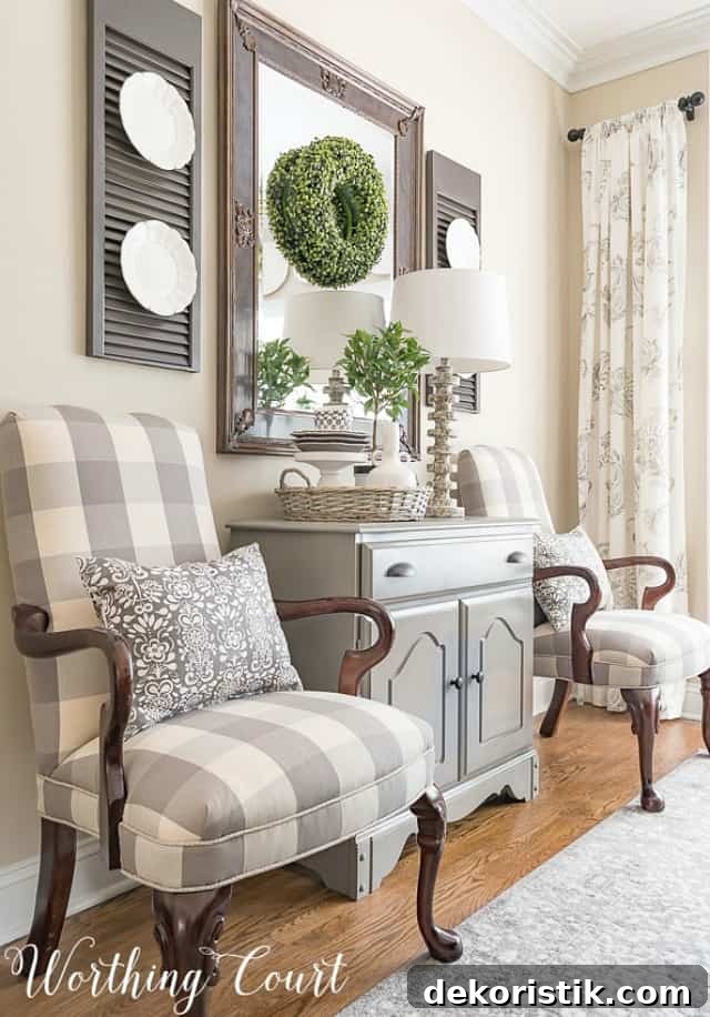 Martha Washington side chairs upholstered with gray and white buffalo check fabric with a small gray chest between them