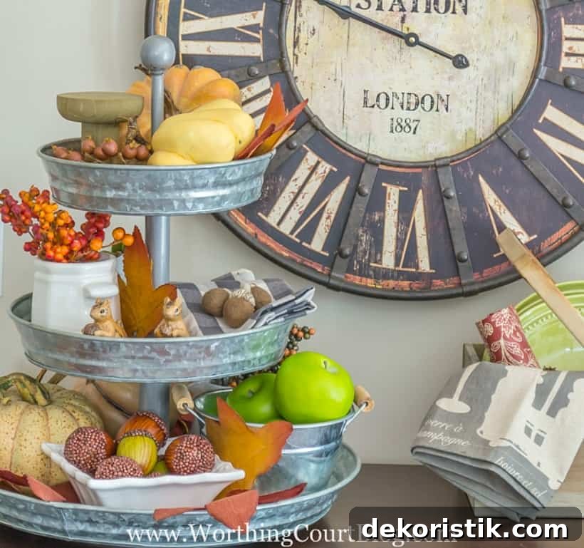 Metal tiered tray filled with a variety of fall decorations.