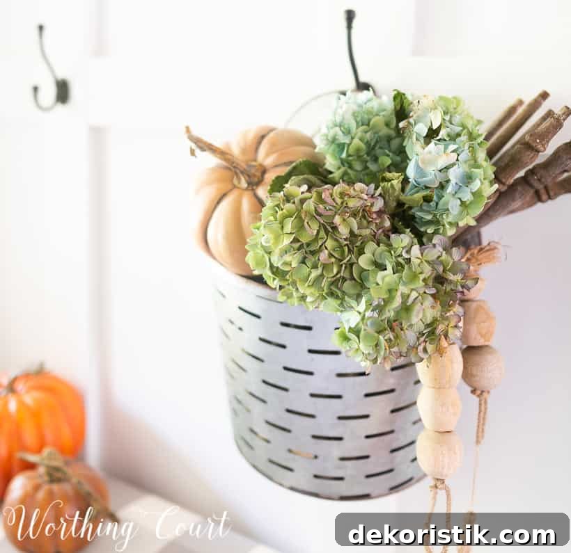 hanging metal bucket filled with fall decorations