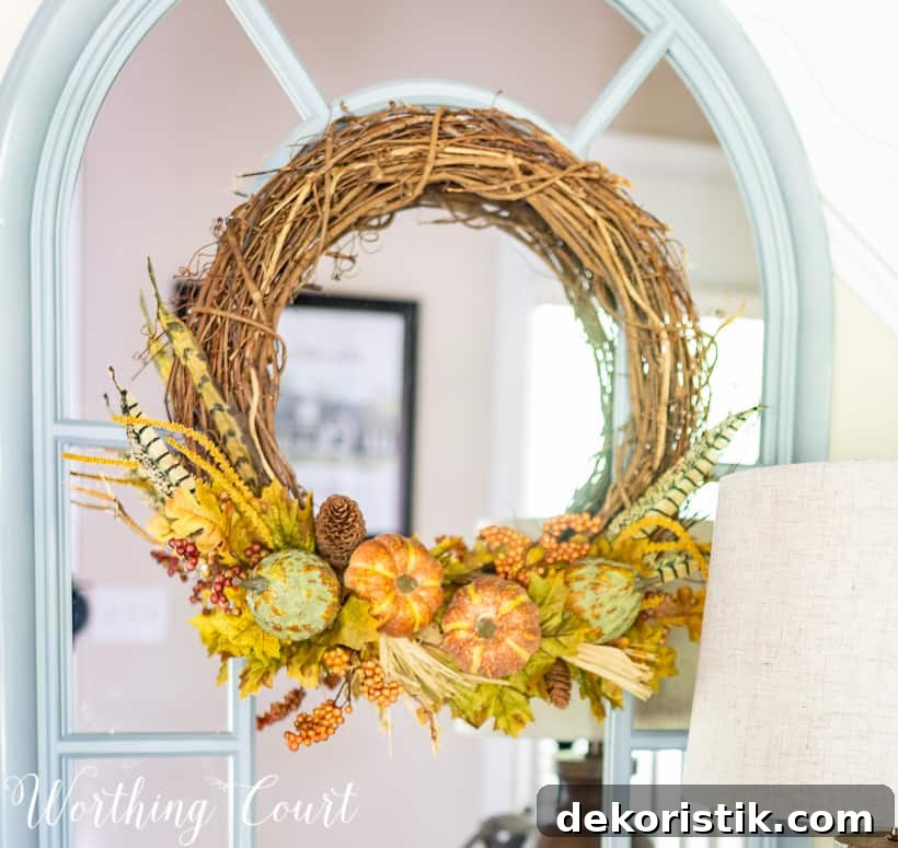 Minimal Fall Foyer Decor Ideas for a Welcoming Entry 5 Grapevine wreath with fall picks.