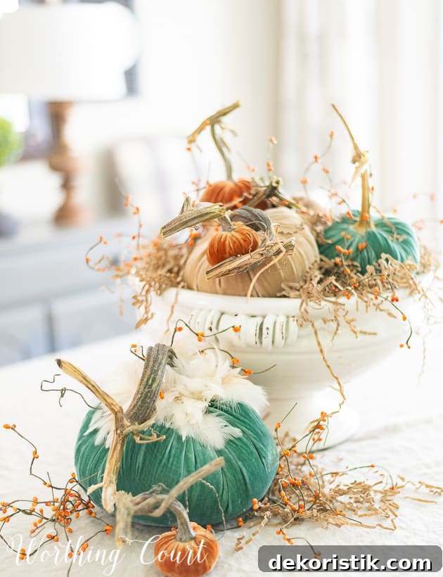 Fall centerpiece with velvet pumpkins green, neutral and orange.