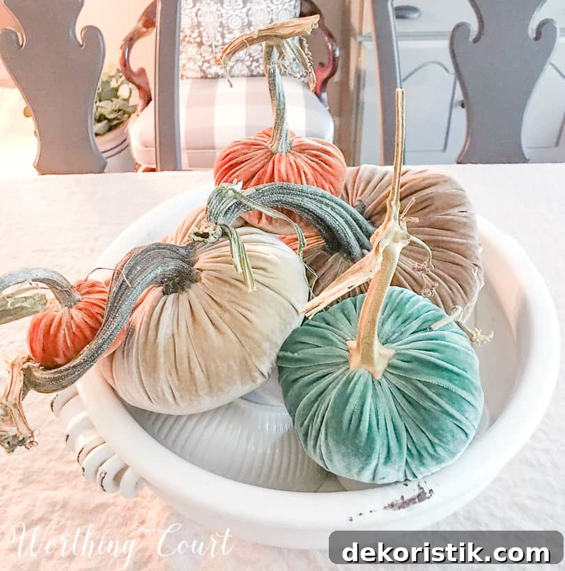 Arranging the pumpkins on top of the white bowls.