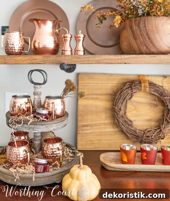 The Moscow mule cups are on a wooden tiered tray that is on the hutch.