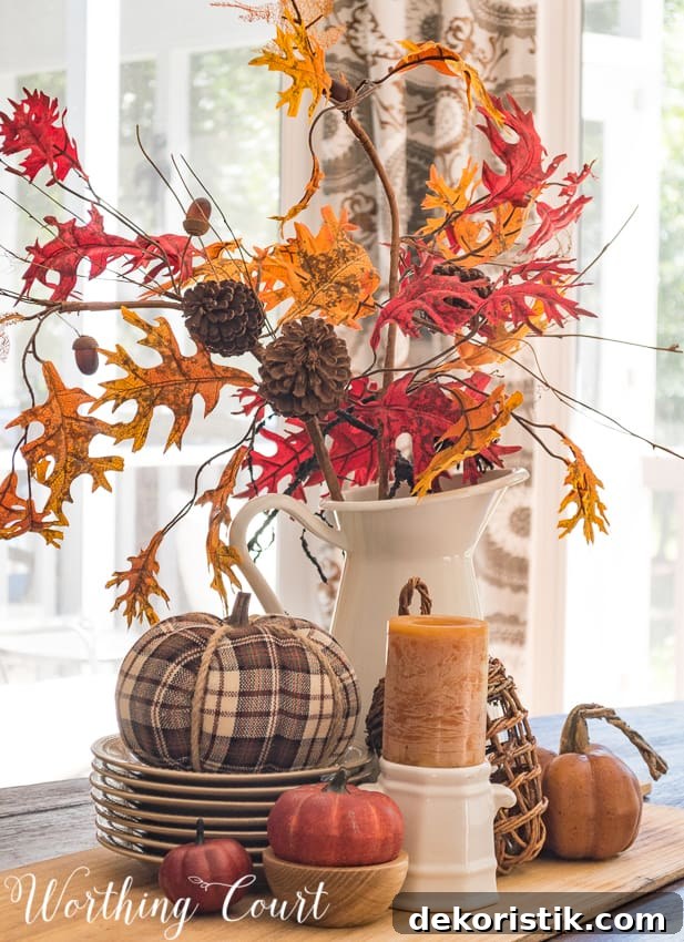 fall centerpieces with fall colored leaves and a plaid pumpkin