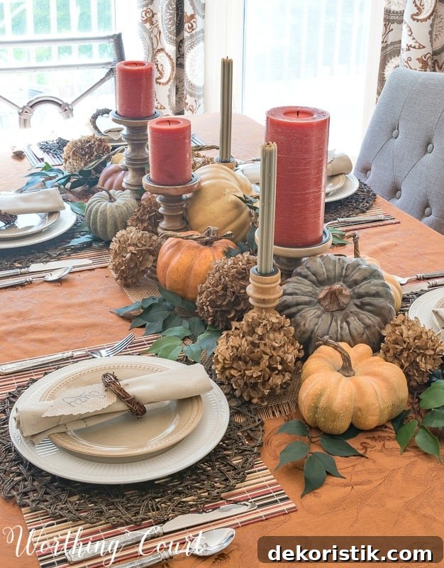 fall centerpiece display with pumpkins and candles