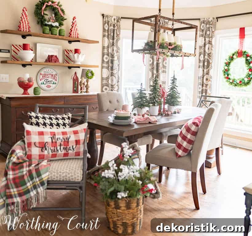 A chair is turned sideways in the room showing a Merry Christmas pillow in a checked pattern.