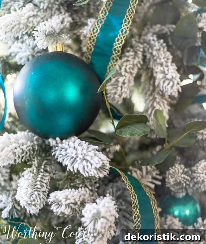 Teal and gold ribbon on the Flocked Christmas tree.