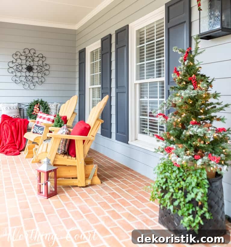 Red lanterns are beside the chairs on the porch.