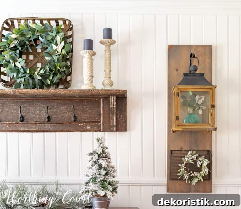 A basket on the wooden shelf that has a eucalyptus wreath inside it.