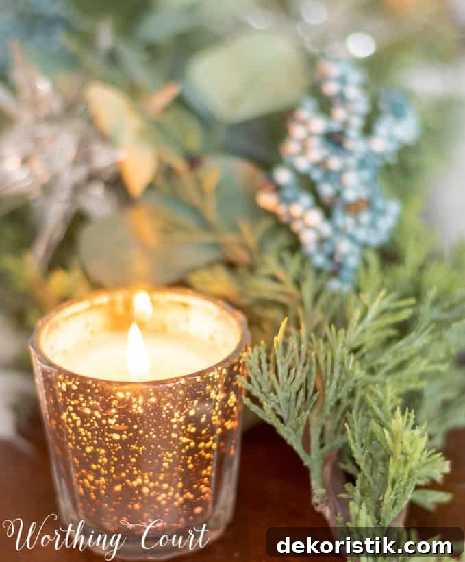 Mercury glass candle votive on the table and is lit.